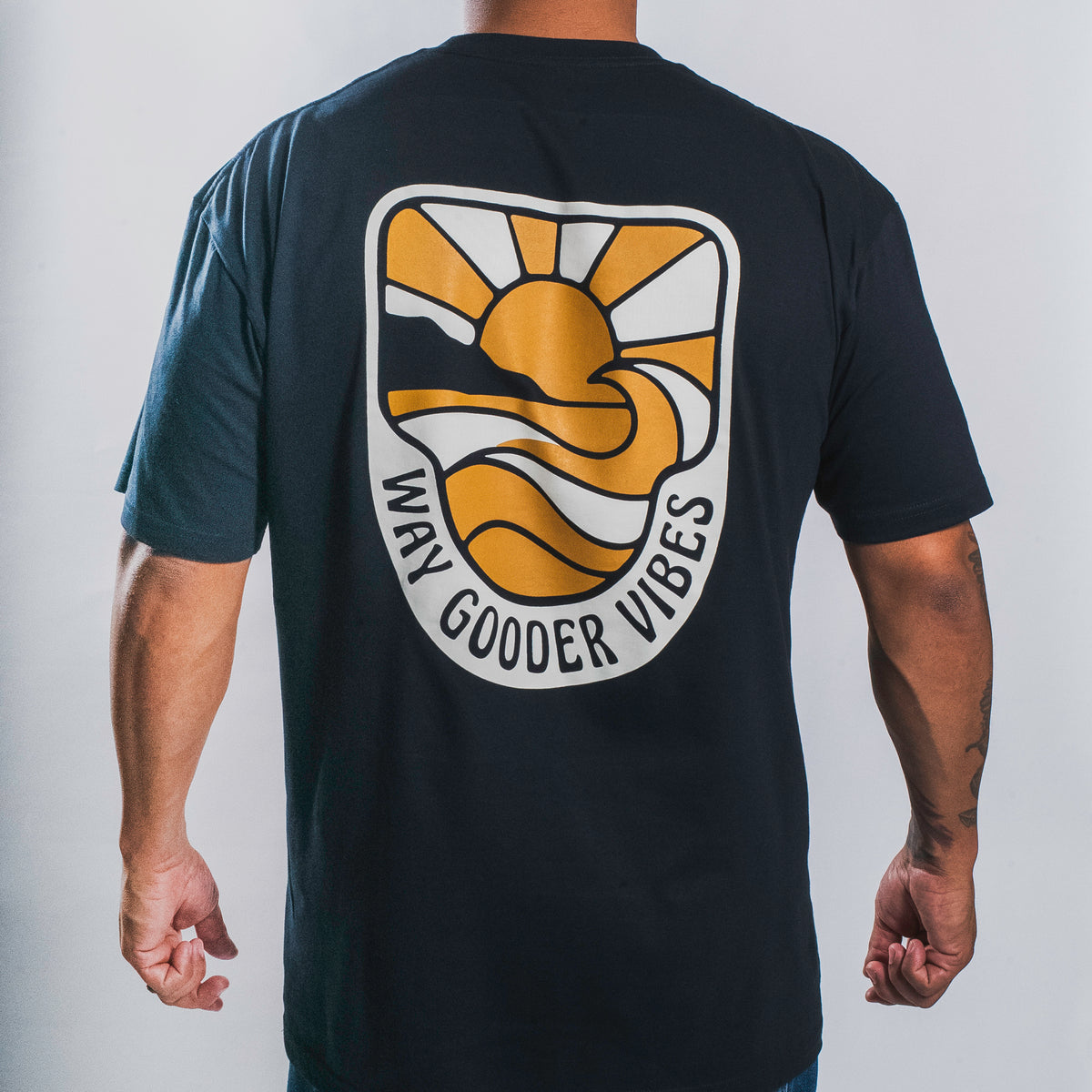 Back view of the navy Golden Horizon Tee with sunset-and-wave artwork