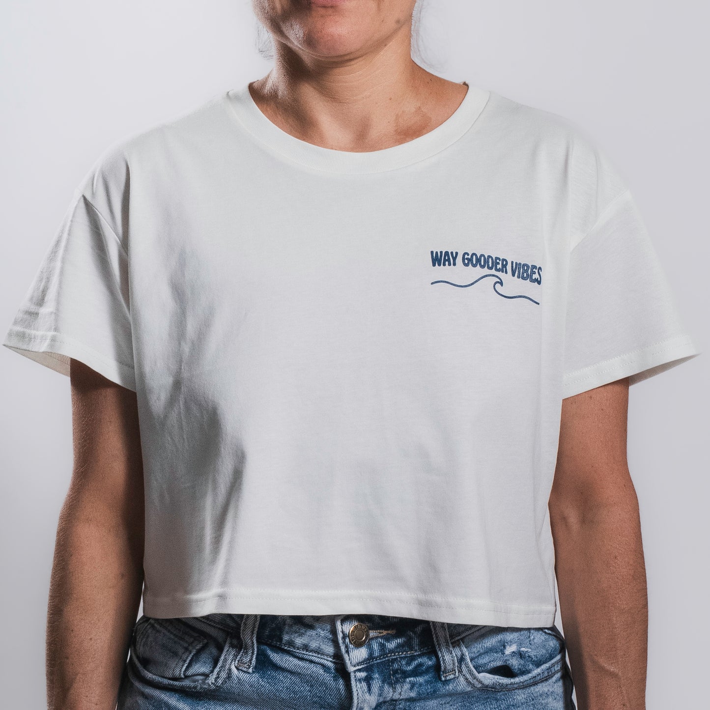 Woman wearing the natural Golden Horizon crop tee, front view