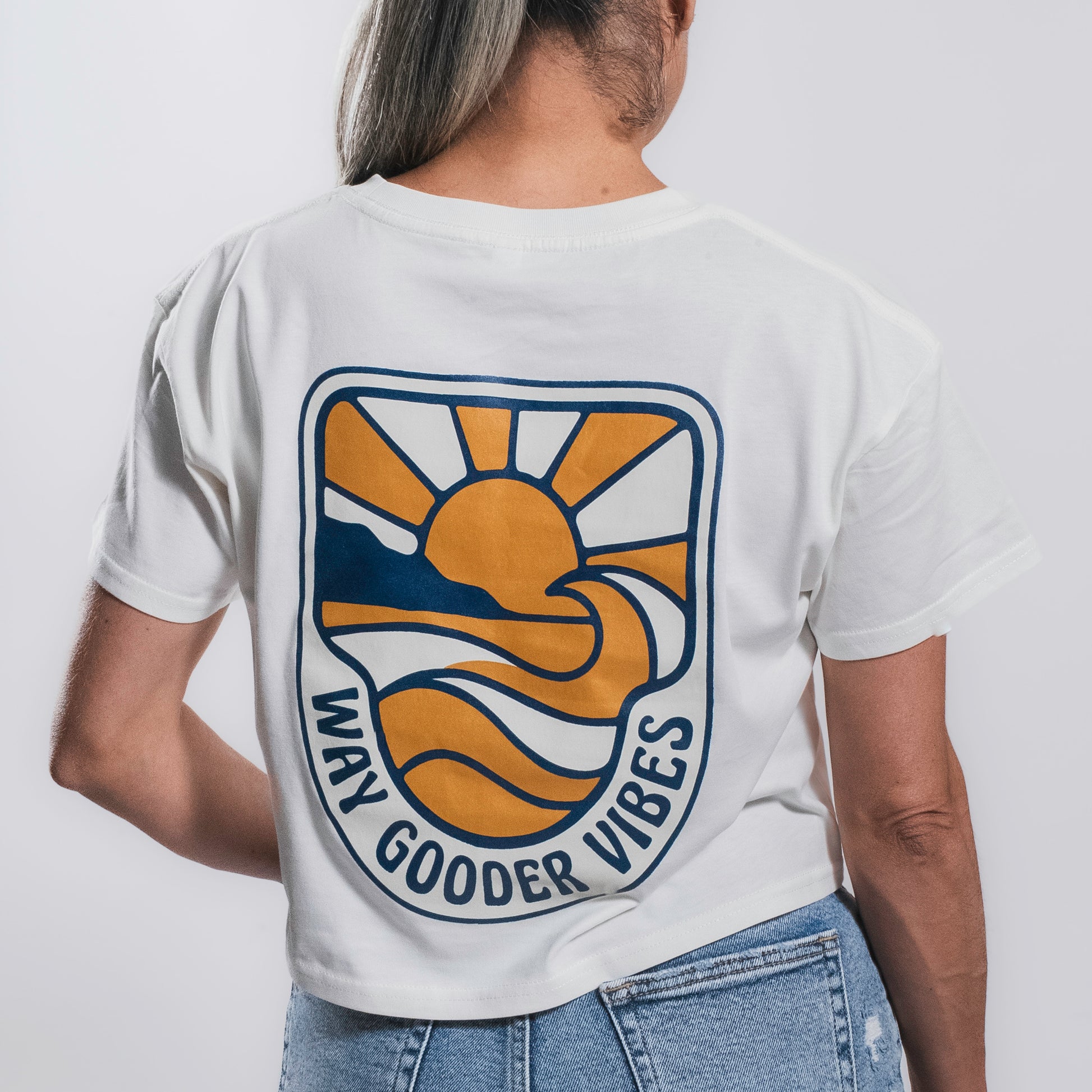 Back view of the Golden Horizon crop tee with sunset-and-wave graphic